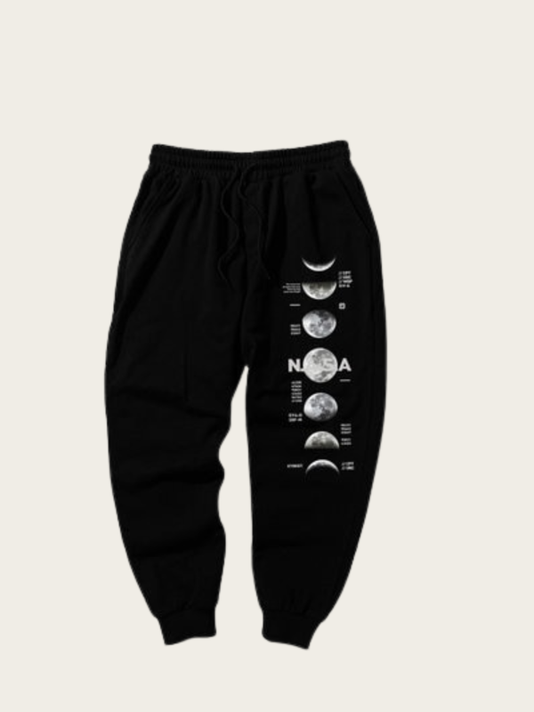 Black sweatpants with NASA moon phase design on a beige background