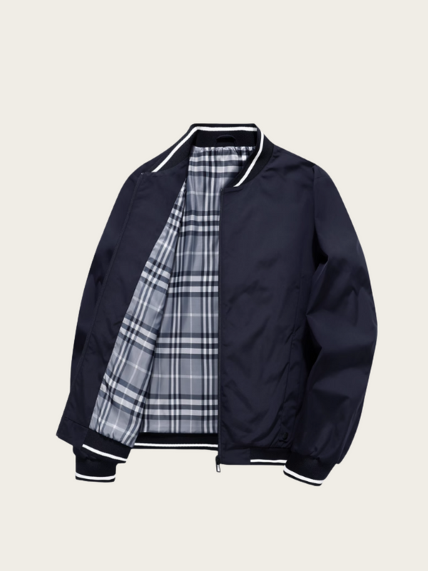 Navy bomber jacket with plaid lining on a beige background