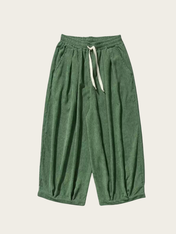 Green pants with a drawstring on a beige background