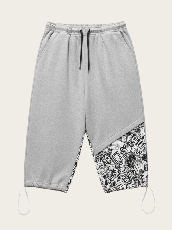 Gray sweatpants with a patterned bottom section on a white background