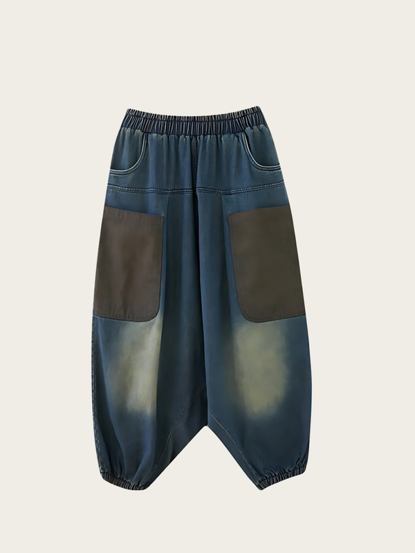 Pair of blue and brown patchwork pants on a light gray background