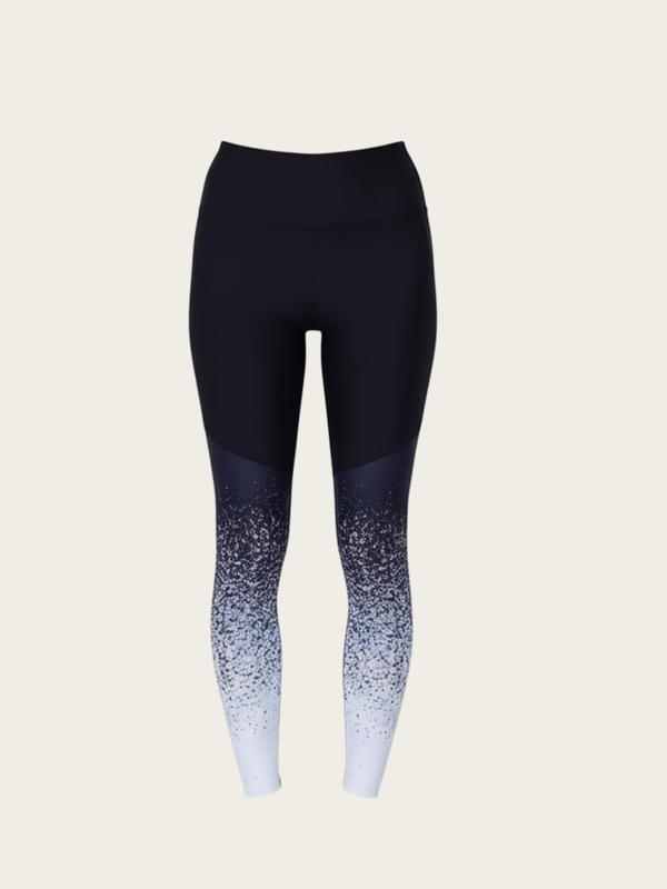 Black leggings with gradient design on a beige background