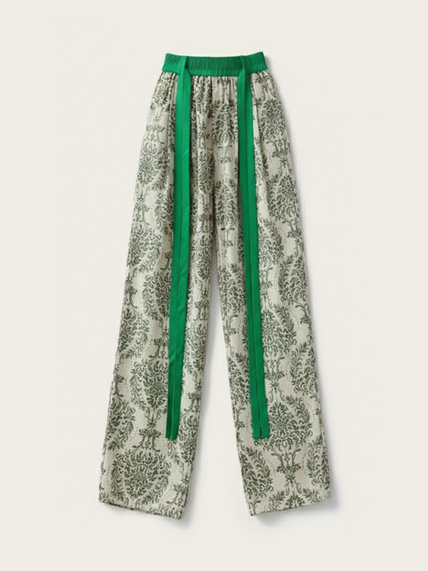 Floral-patterned pants with green accents on a light background