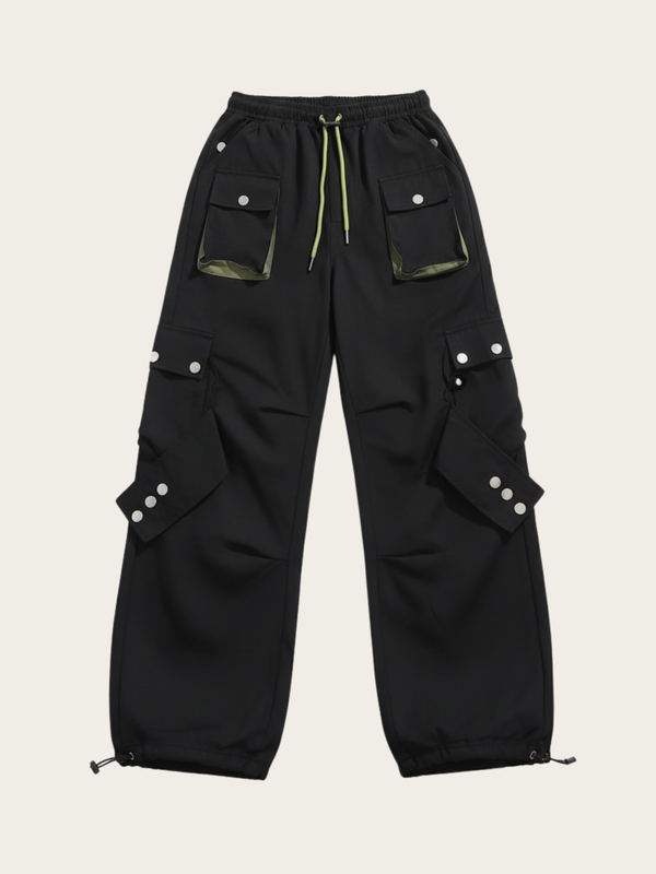 Black cargo pants with multiple pockets and buttons on a beige background