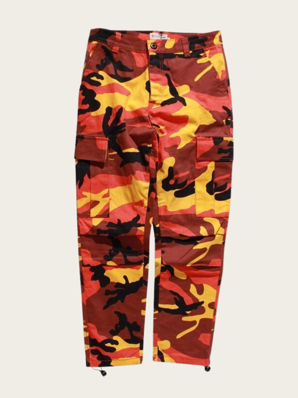 Camouflage pants with red, yellow, and black pattern on a white background