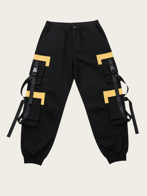Black cargo pants with yellow accents and black straps on a beige background