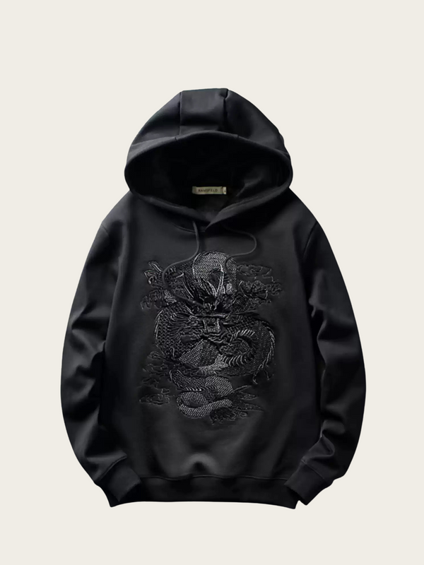 Black hoodie with dragon design on a beige background