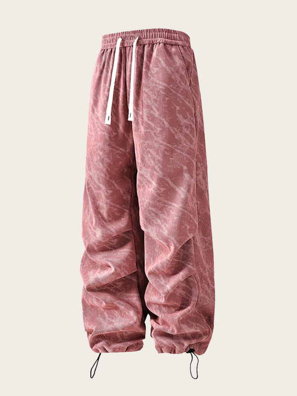 Pink velour jogger pants on a white background