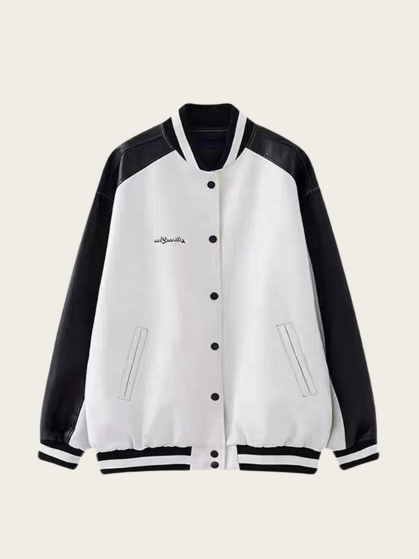 White varsity jacket with black sleeves on a beige background