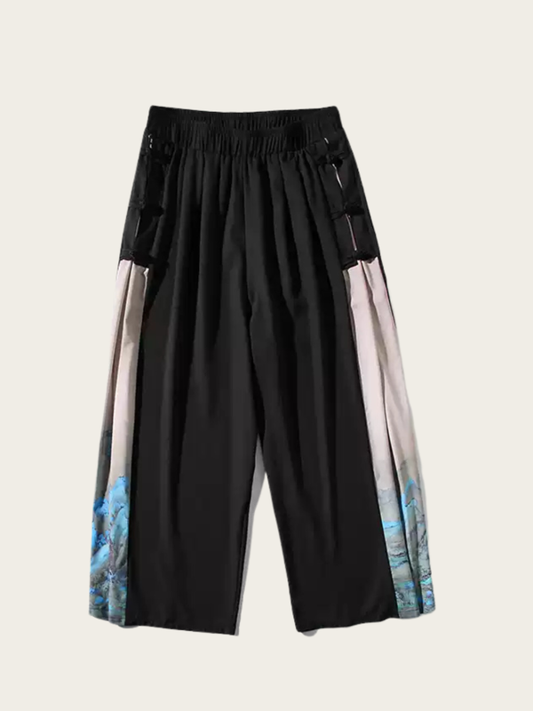 Black pants with colorful side panels on a light gray background