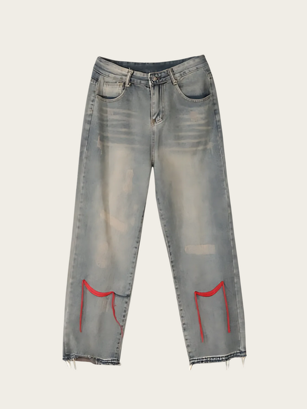 Gray distressed jeans with red accents on a light gray background