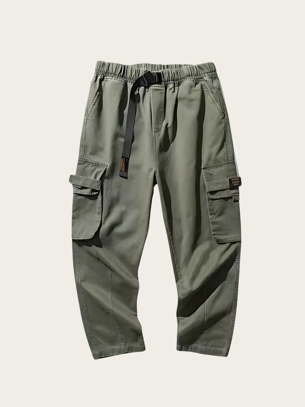 Green cargo pants on a light beige background