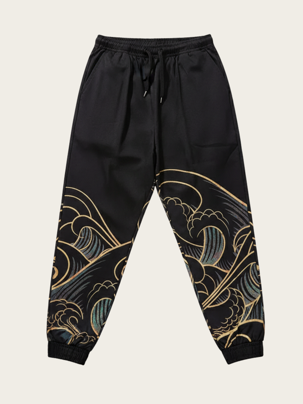 Black pants with gold and green wave patterns on a beige background