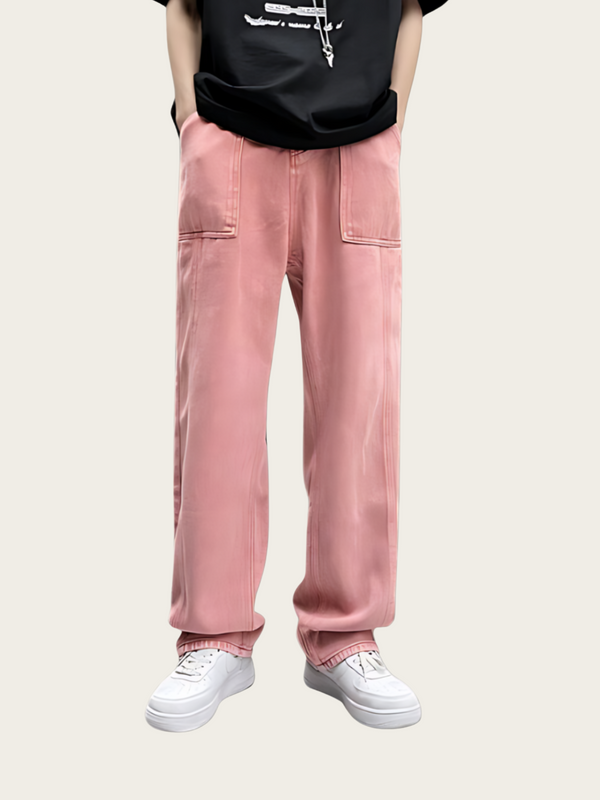 Person wearing pink pants and white sneakers on a plain background