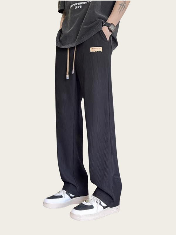 Person wearing black pants with a white background