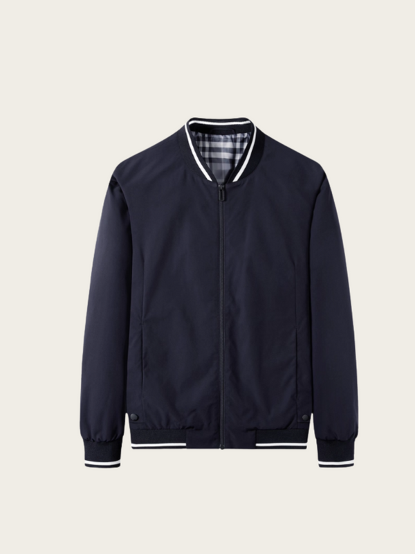 Navy blue bomber jacket with plaid lining on a light beige background