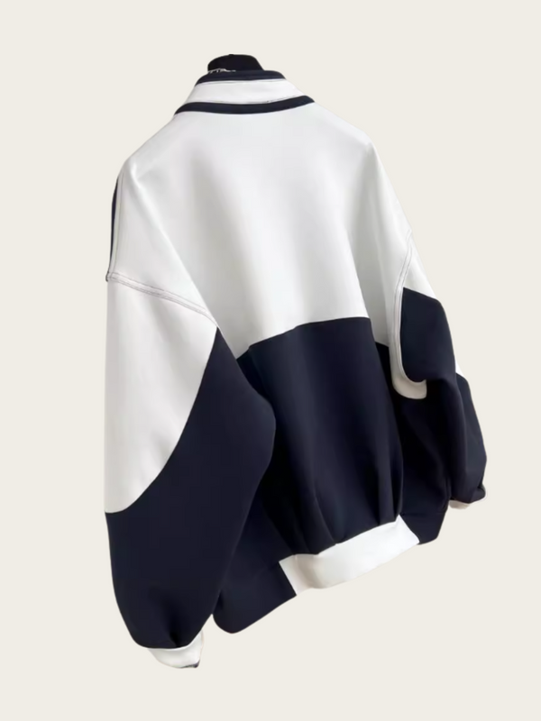 White and navy blue poncho on a beige background