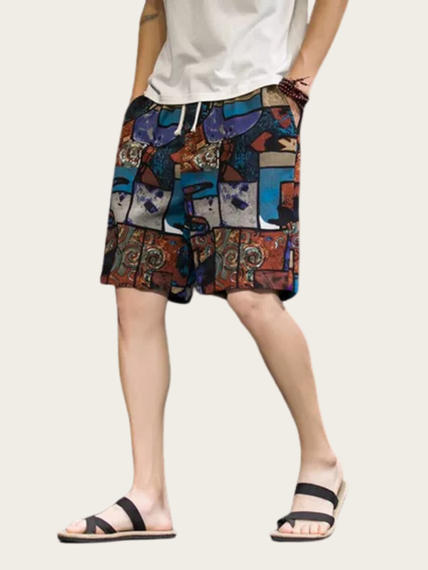 Person wearing colorful patterned shorts on a plain background
