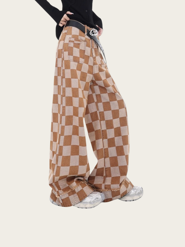 Brown and beige checkered pants worn by a person on a white background