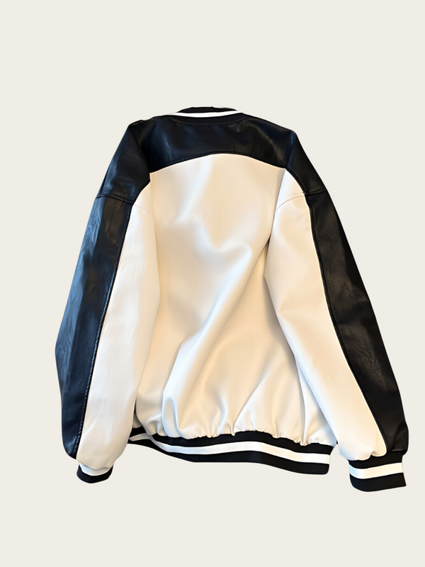 White varsity jacket with black sleeves on a light gray background