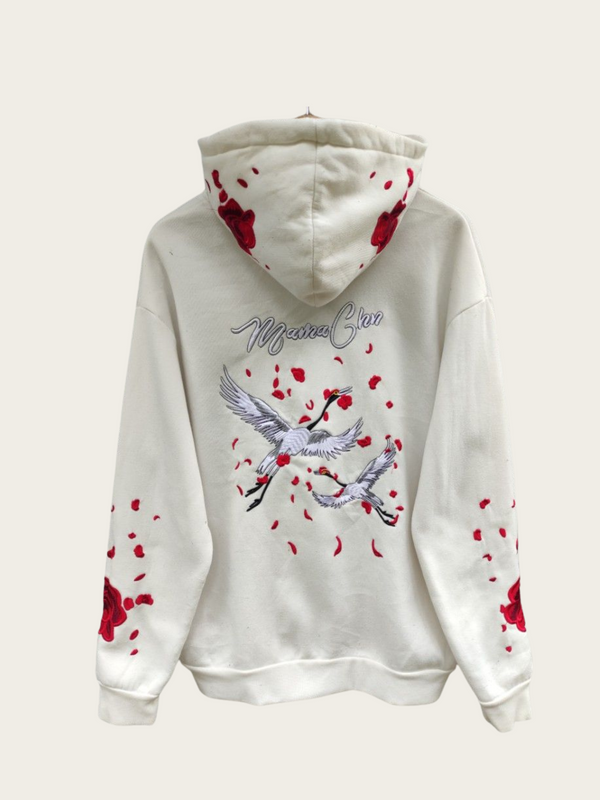 White hoodie with red floral patterns and a bird design on a white background