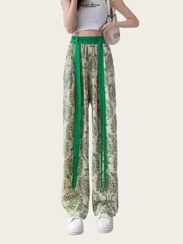 Green and white floral-patterned pants with a green stripe on a white background