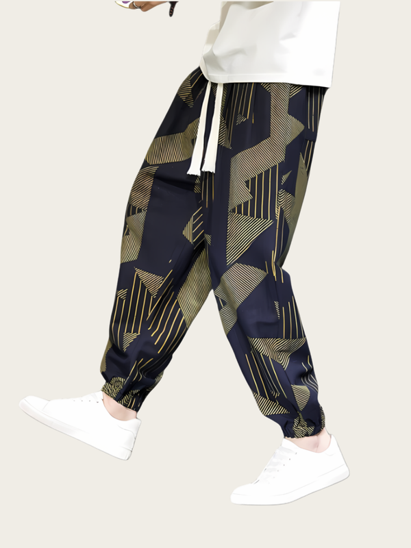 Person wearing navy jogger pants with geometric pattern on a white background
