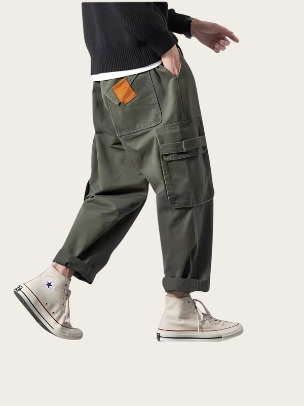 Person wearing green cargo pants with a white background