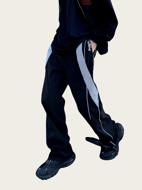 Black tracksuit with white stripes on a beige background