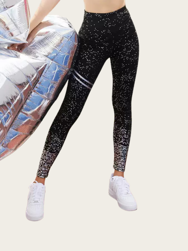 Black glittery leggings with white stripes worn by a person on a light gray background