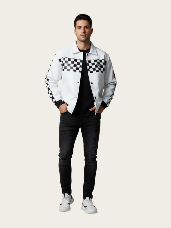 Man wearing a white jacket with black checkered patterns, black pants, and white sneakers on a light gray background