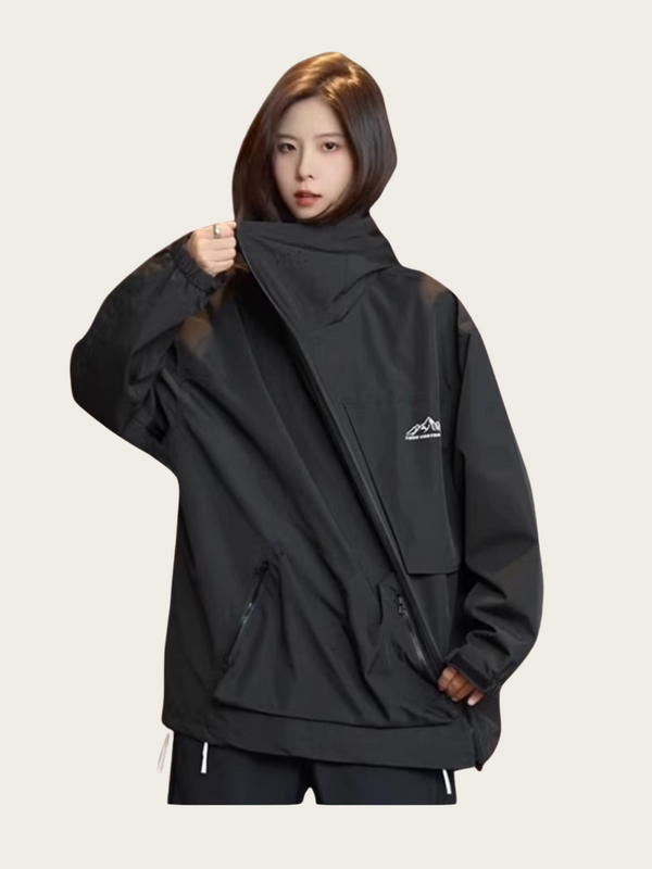 Person wearing a black jacket with a logo on a light gray background