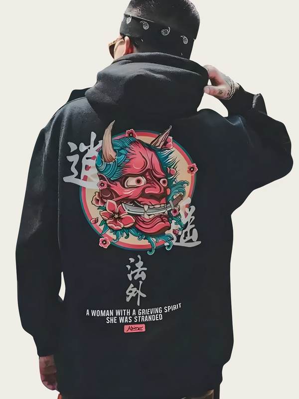 Person wearing a black hoodie with a colorful graphic design on the back against a plain background