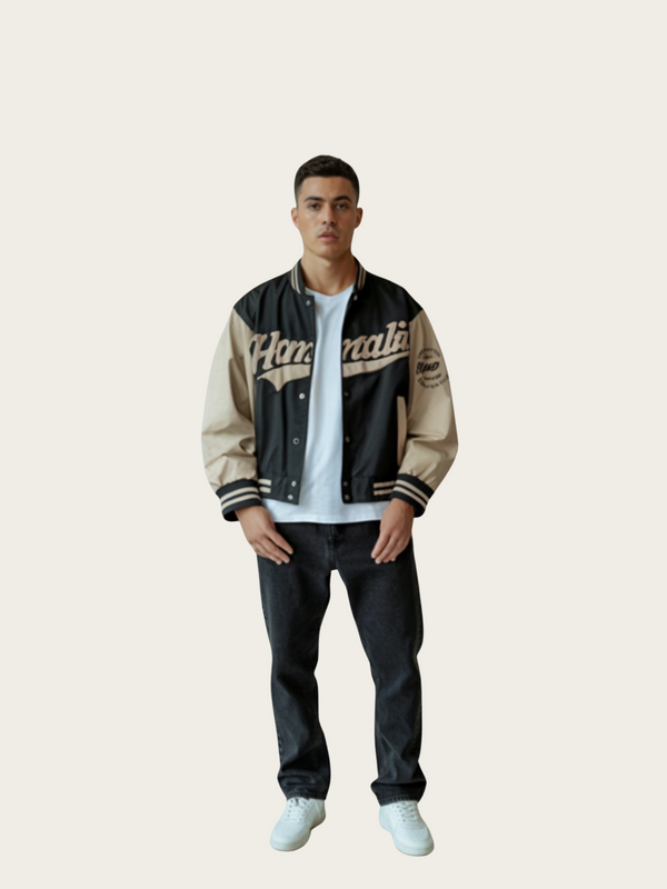 Person wearing a black and beige varsity jacket on a white background