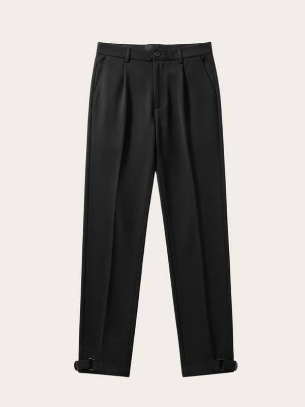 Black pleated pants on a beige background