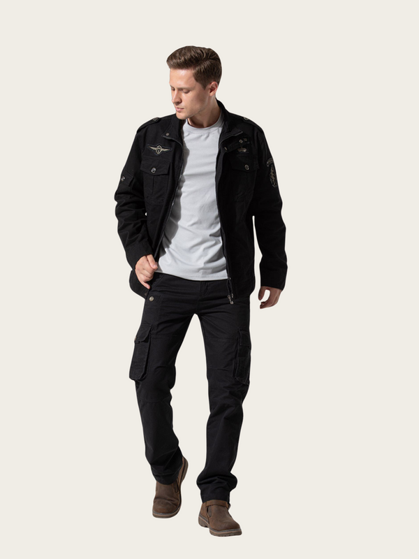 Man wearing a black jacket and pants on a white background