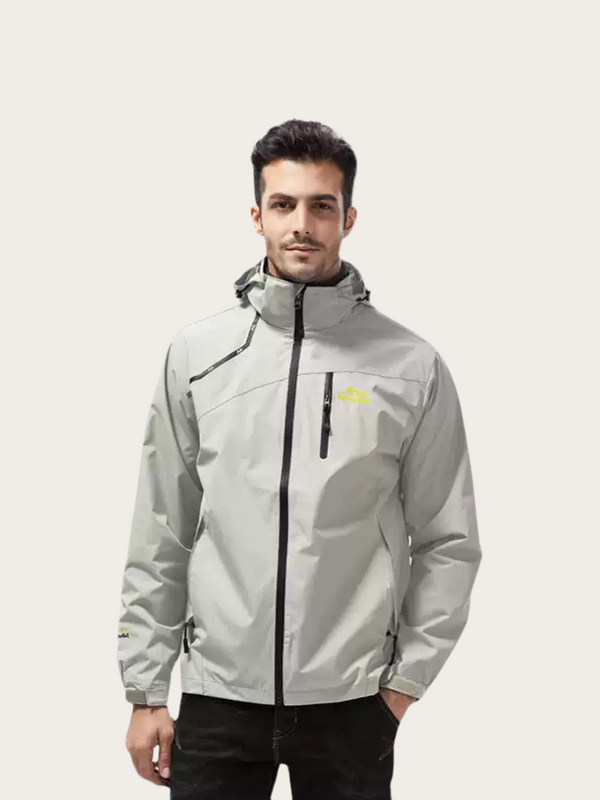 Man wearing a light gray jacket with a brand logo on a white background