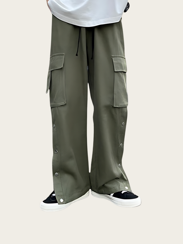 Person wearing olive green cargo pants on a light beige background