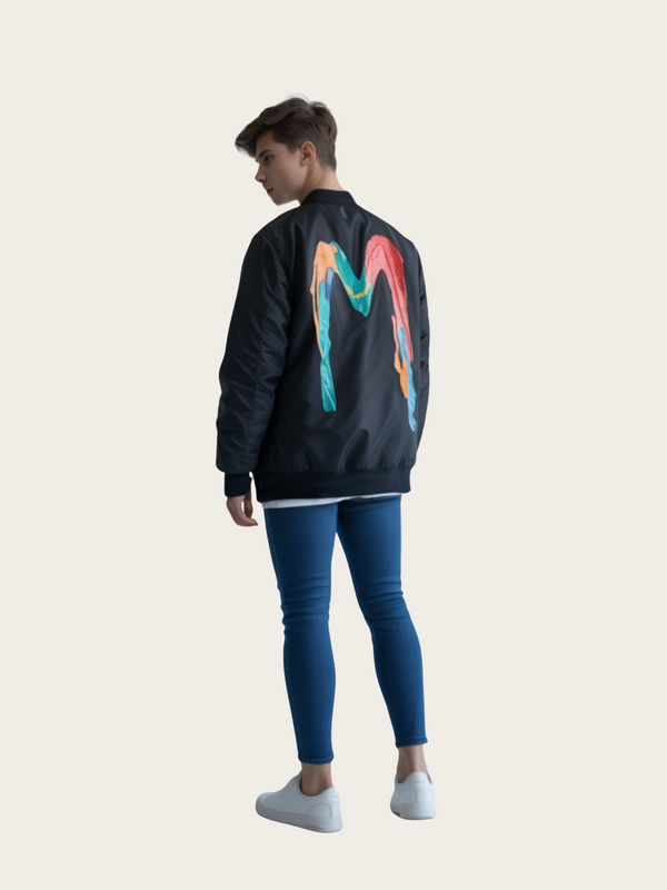 Person wearing a black jacket with colorful designs on the back, standing against a plain background.