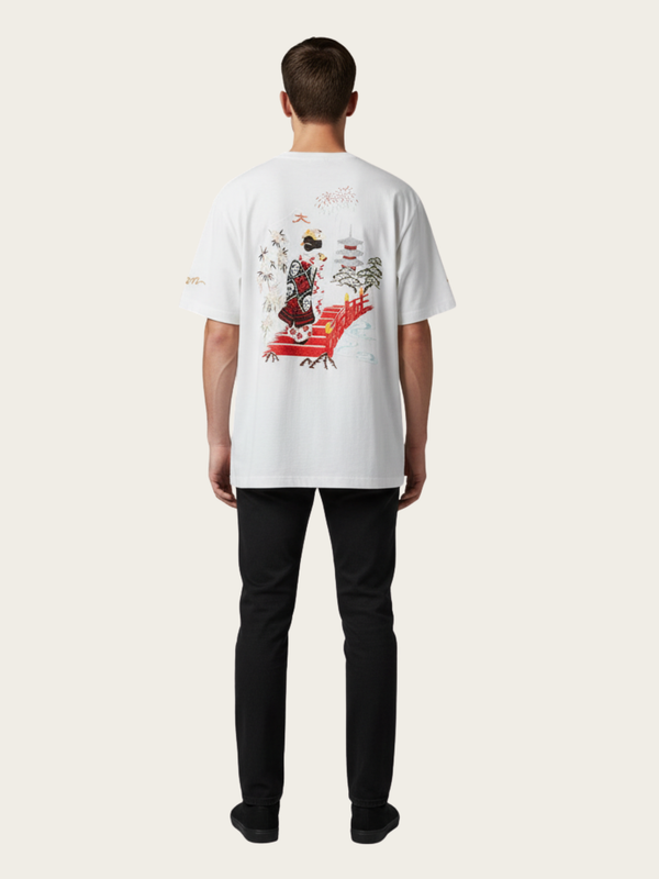 Person wearing a white t-shirt with a colorful graphic on the back, standing against a plain background.