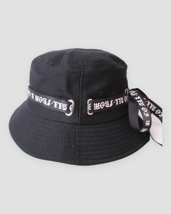Black bucket hat with a white blackletter ribbon through silver rings, three-quarter view
