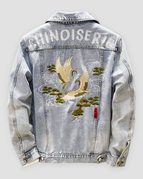 Light-wash denim jacket, back view, CHINOISERIE lettering above an embroidered crane