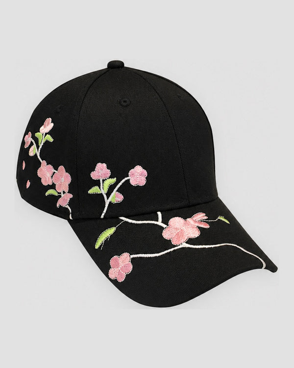 Black baseball cap with a pink plum blossom branch embroidered across the brim