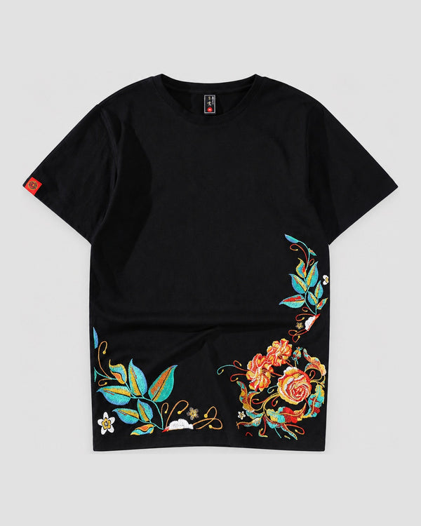 Black cotton tee with roses and teal leaves embroidered along the lower hem