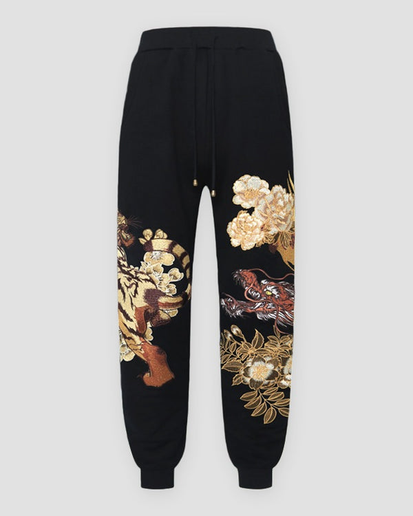 Black tiger dragon embroidered joggers, front view
