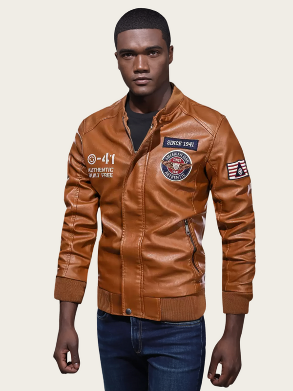 Man wearing a brown leather jacket with patches on a beige background