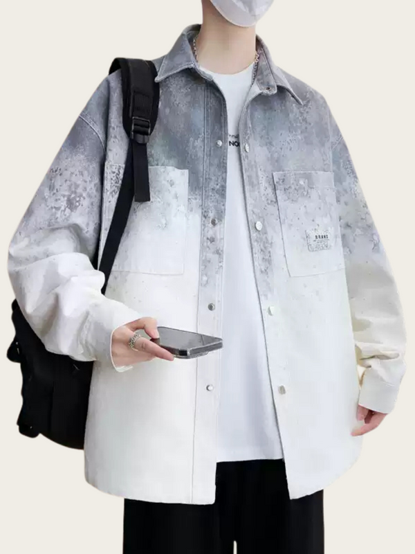Person wearing a light gray and white shirt with a black backpack and holding a phone.