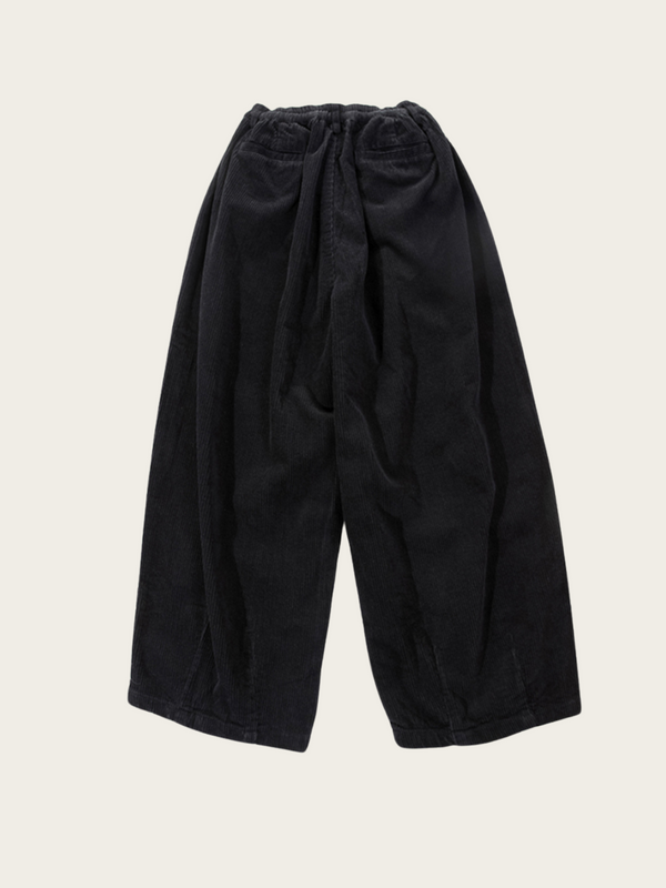 Black pants on a beige background