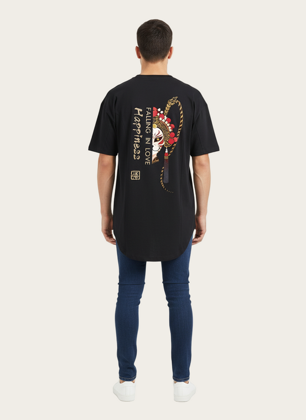 Person wearing a black t-shirt with a graphic design on the back, standing against a white background