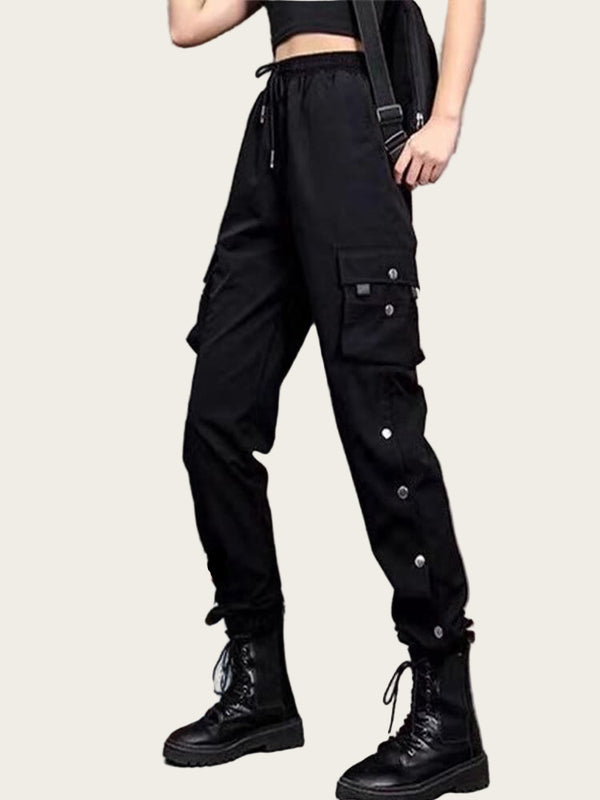 Person wearing black cargo pants with a fiery graphic and text on a yellow background